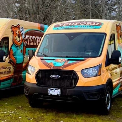 A row of Tedford Garage Doors service vans