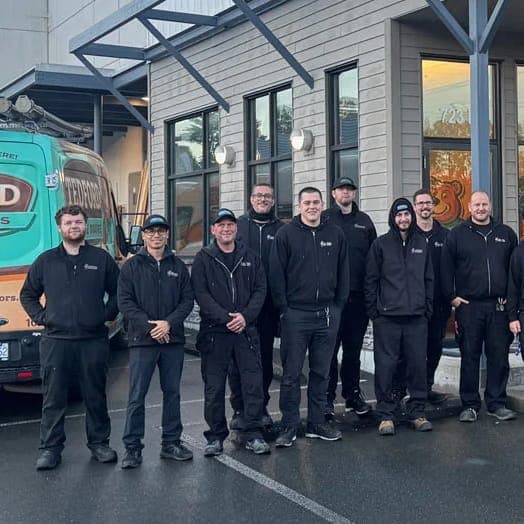 Members of the Tedford Victoria crew standing together outside the shop