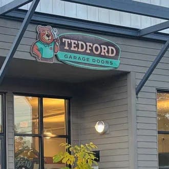 The Tedford Garage Doors sign with the bear mascot over the Victoria shop entrance
