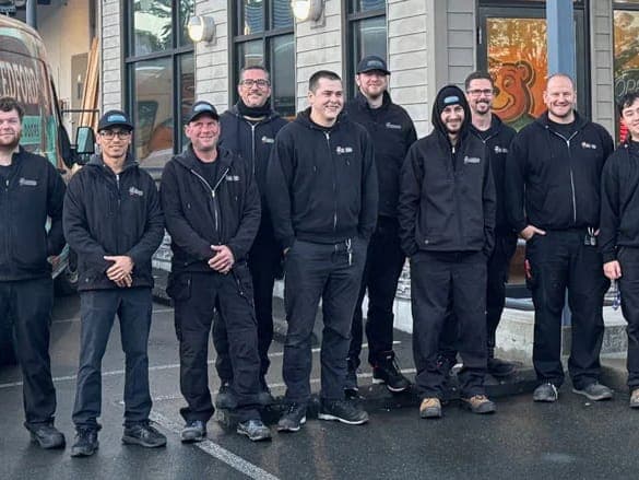 Members of the Tedford Garage Doors Victoria team in Tedford jackets in front of a Tedford service van